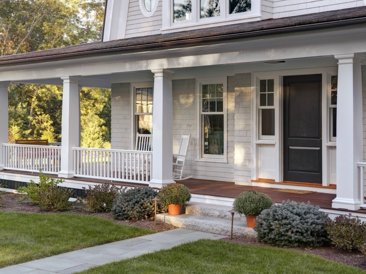 A covered porch with rocking chairs, the cover of the Home Selling Guide
